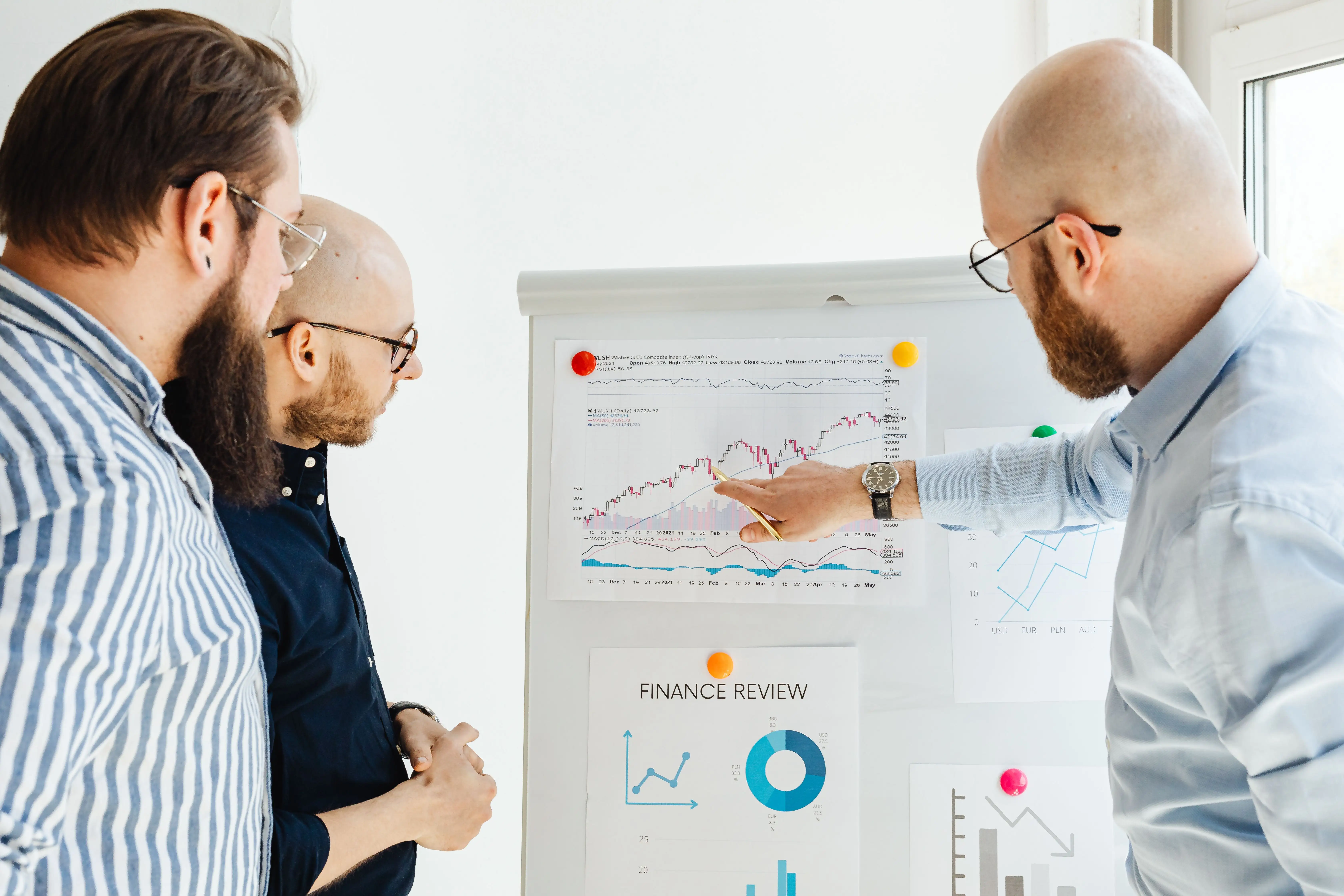 Investment professionals reviewing research and market data